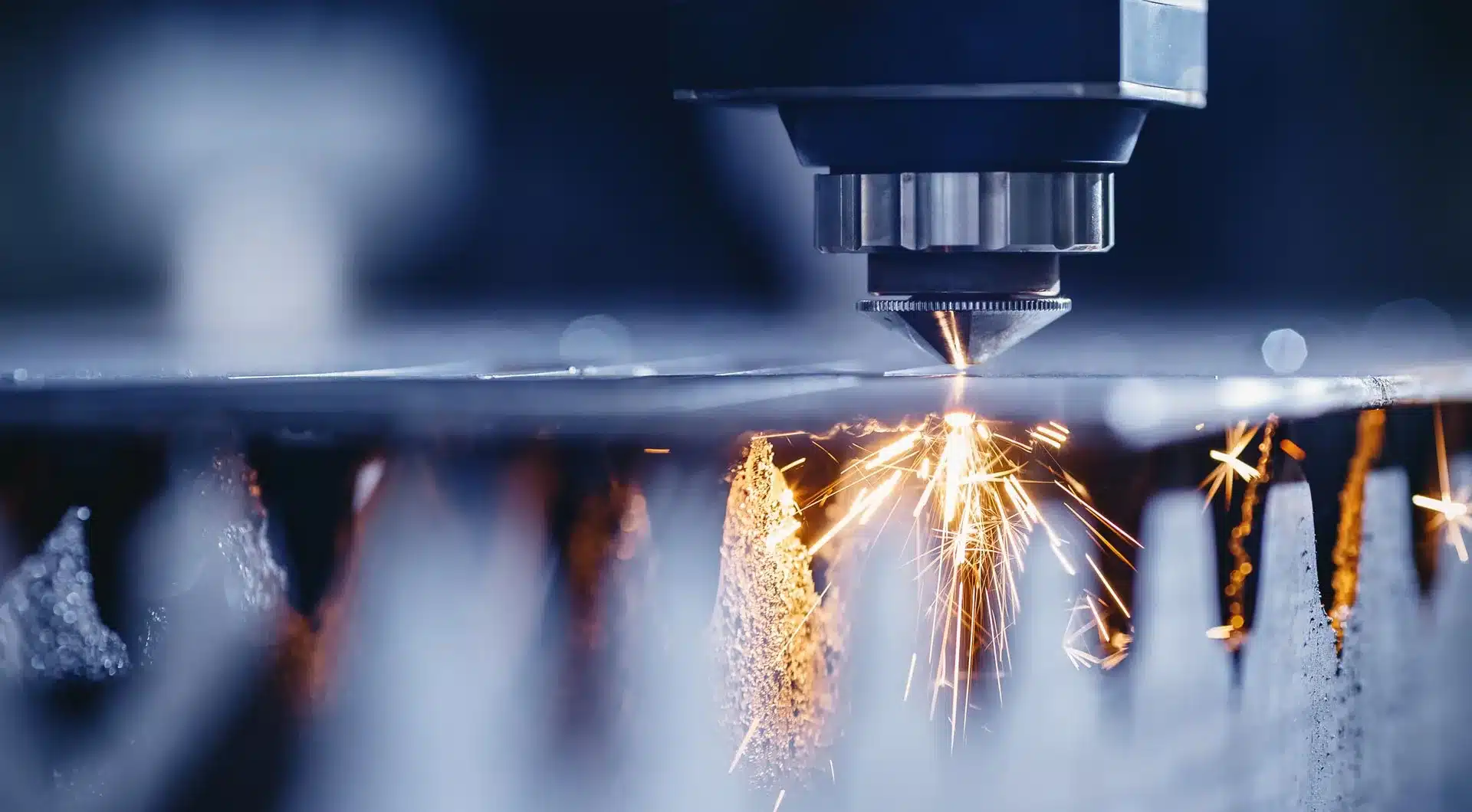 Laser cutting metal with sparks flying, showcasing precision technology for industrial applications.